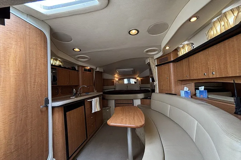 Slide: The Image of Luxurious interior of a 2006 Sea Ray 340 Sundancer yacht with wood cabinetry and seating. - 19