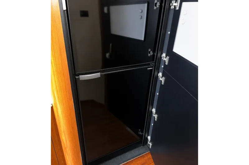Slide: The Image of Interior view of a 2001 Sea Ray 450 Express Bridge yacht, featuring a sleek black door. - 18