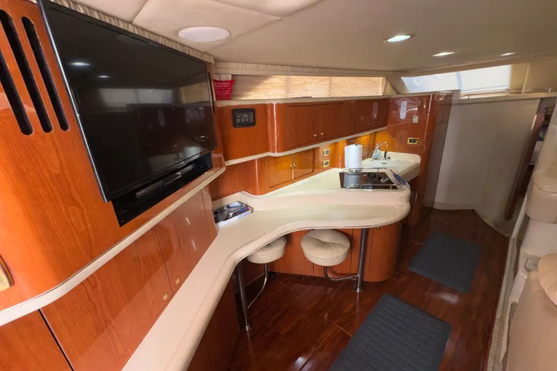 Slide: The Image of Luxurious interior of 2001 Sea Ray 450 Express Bridge yacht with modern amenities. - 16