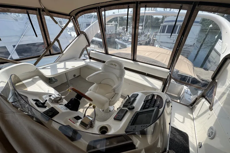 Slide: The Image of 2001 Sea Ray 450 Express Bridge helm with luxurious seating and advanced navigation controls. - 9