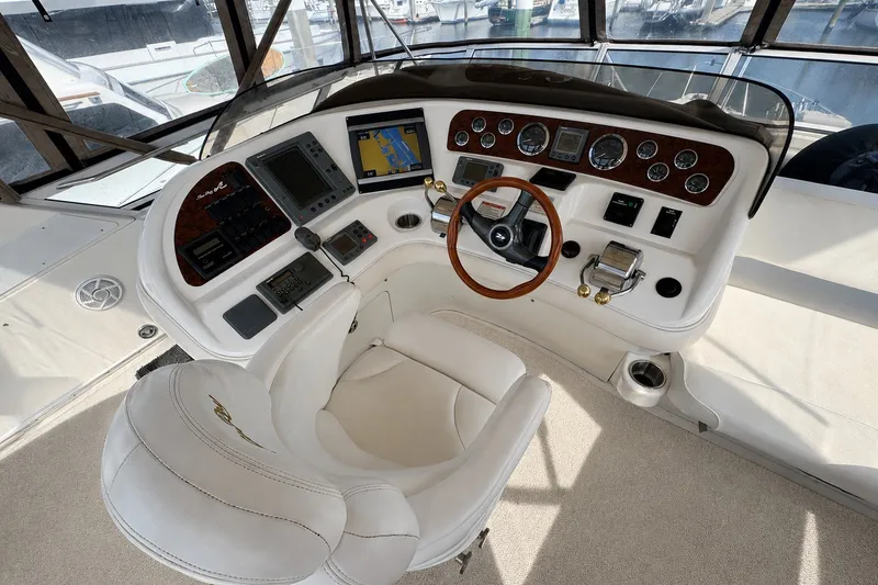 Slide: The Image of Helm of 2001 Sea Ray 450 Express Bridge with navigation instruments and steering wheel. - 11