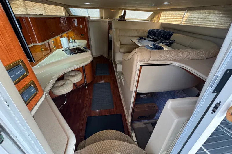 Slide: The Image of Interior of 2001 Sea Ray 450 Express Bridge yacht with luxurious seating and kitchenette. - 14