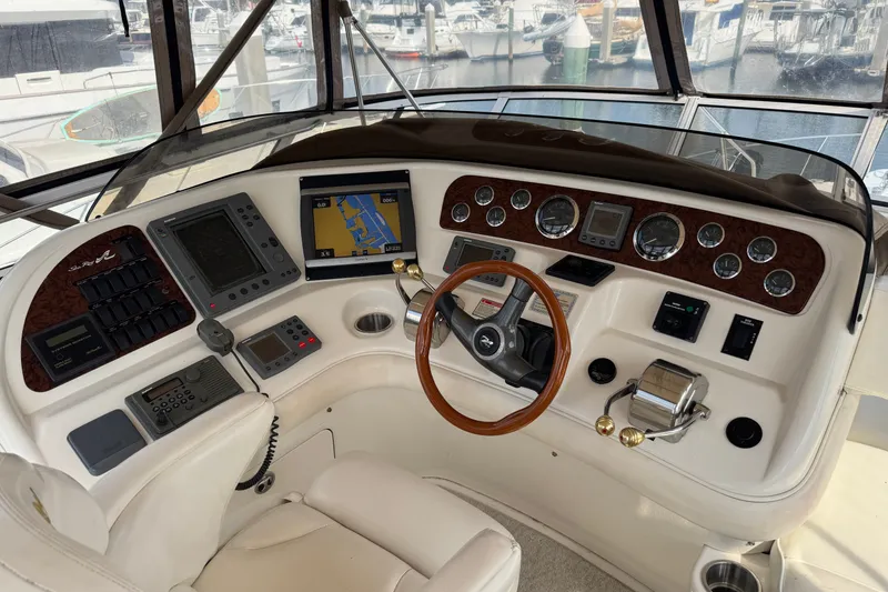 Slide: The Image of Cockpit of 2001 Sea Ray 450 Express Bridge with navigation instruments and steering wheel. - 12