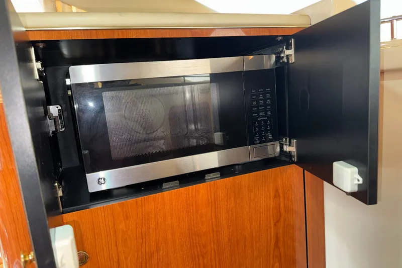 Slide: The Image of Microwave inside 2001 Sea Ray 450 Express Bridge yacht's wooden cabinet. - 20