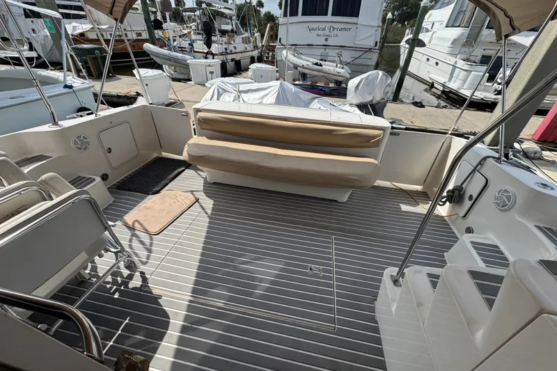 Slide: The Image of Spacious deck of 2001 Sea Ray 450 Express Bridge yacht, featuring comfortable seating and sleek design. - 8
