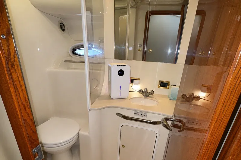Slide: The Image of Bathroom interior of 2001 Sea Ray 450 Express Bridge yacht, featuring sink and toilet. - 27
