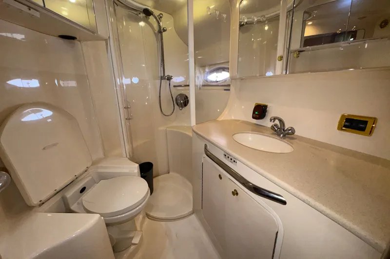 Slide: The Image of Luxurious bathroom in 2001 Sea Ray 450 Express Bridge yacht, featuring shower, toilet, and sink. - 25