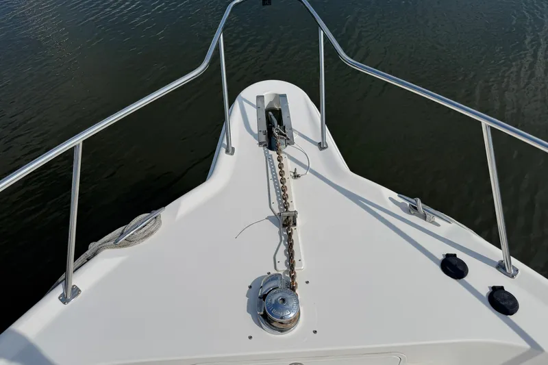 Slide: The Image of Bow view of 2001 Sea Ray 450 Express Bridge with anchor chain and railing. - 7