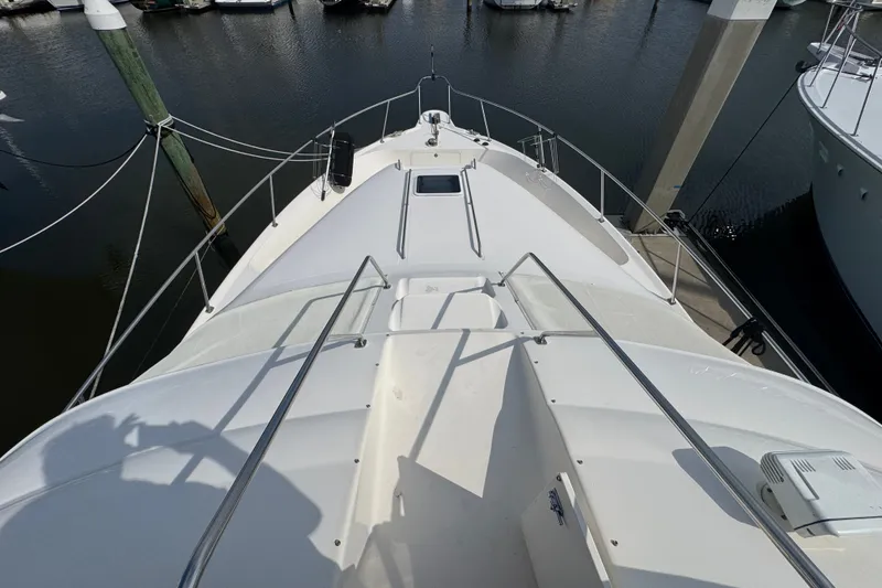 Slide: The Image of 2001 Sea Ray 450 Express Bridge yacht deck view at marina. - 6