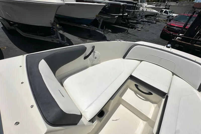 Slide: The Image of 2016 Sea Ray SPX 210 Outboard boat interior with white seating and gray accents. - 8