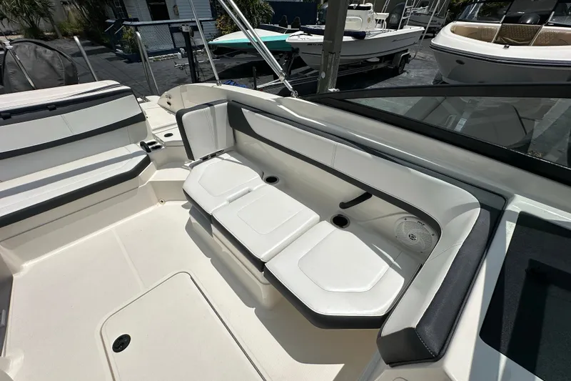 Slide: The Image of 2016 Sea Ray SPX 210 Outboard boat interior with white seating and cup holders. - 11