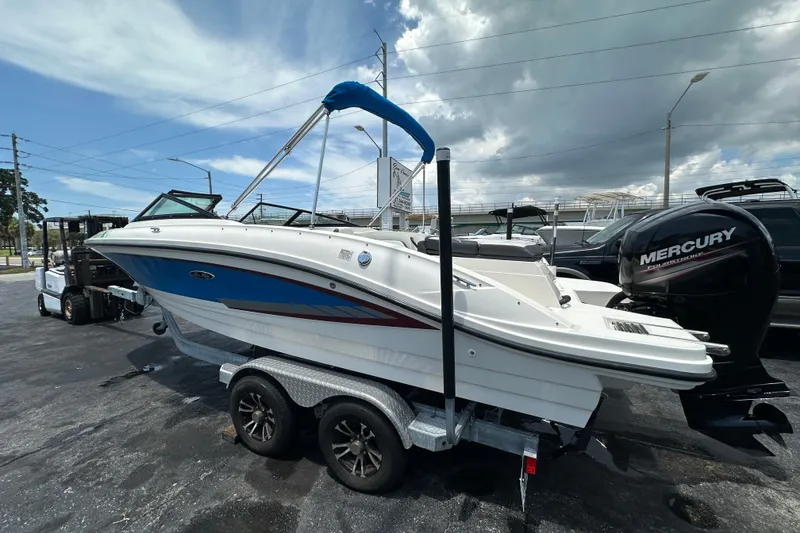 Slide: The Image of 2016 Sea Ray SPX 210 Outboard boat on trailer, featuring a Mercury engine. - 4