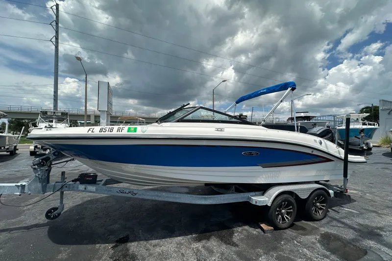 Slide: The Image of 2016 Sea Ray SPX 210 Outboard boat on trailer under cloudy sky. - 5