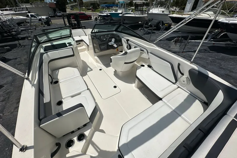 Slide: The Image of 2016 Sea Ray SPX 210 Outboard boat interior with white seating and steering console. - 14