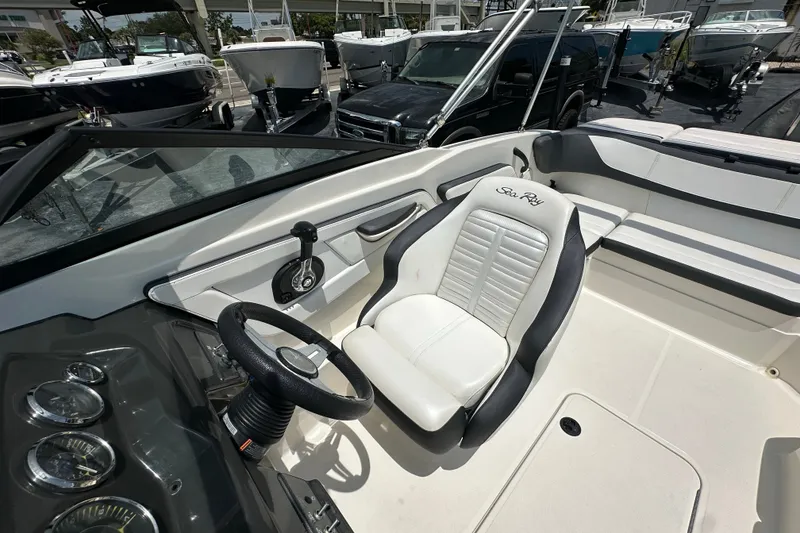 Slide: The Image of 2016 Sea Ray SPX 210 Outboard boat interior with steering wheel and seating. - 10