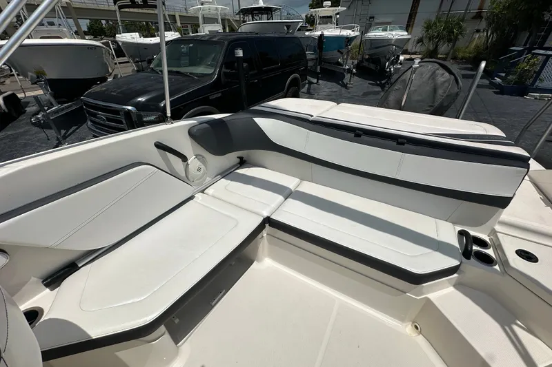 Slide: The Image of 2016 Sea Ray SPX 210 Outboard boat interior with white seating and cup holders. - 12