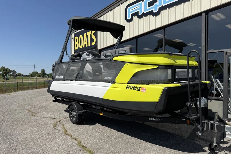 The Image of 2024 Sea-Doo Switch Cruise 21 pontoon boat on trailer outside dealership. - 0