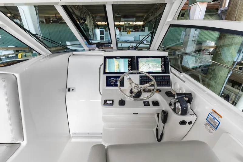 Slide: The Image of 2018 Boston Whaler 345 Conquest helm with dual navigation screens and steering wheel. - 33