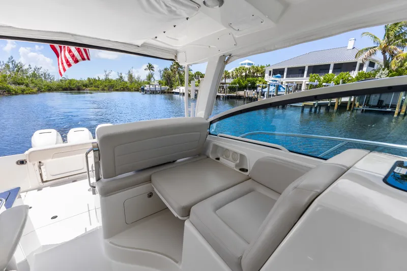 Slide: The Image of 2018 Boston Whaler 345 Conquest interior with waterfront view and American flag. - 31