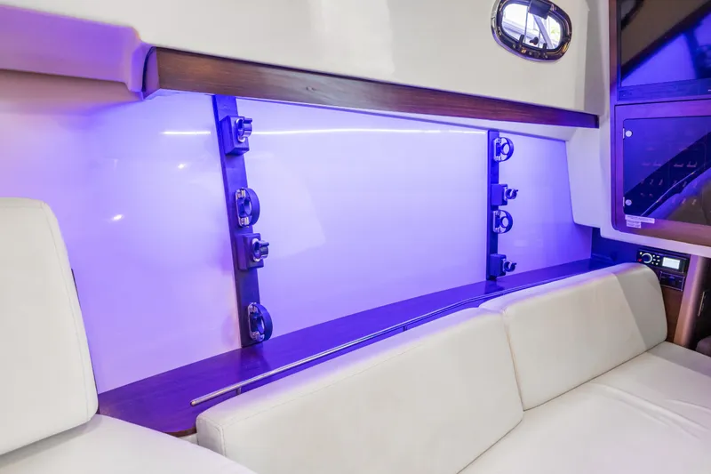 Slide: The Image of Interior of 2018 Boston Whaler 345 Conquest with ambient blue lighting and seating. - 40