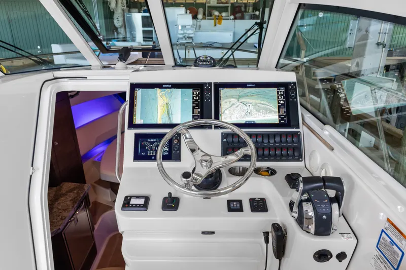 Slide: The Image of Control panel of a 2018 Boston Whaler 345 Conquest boat with navigation screens. - 34
