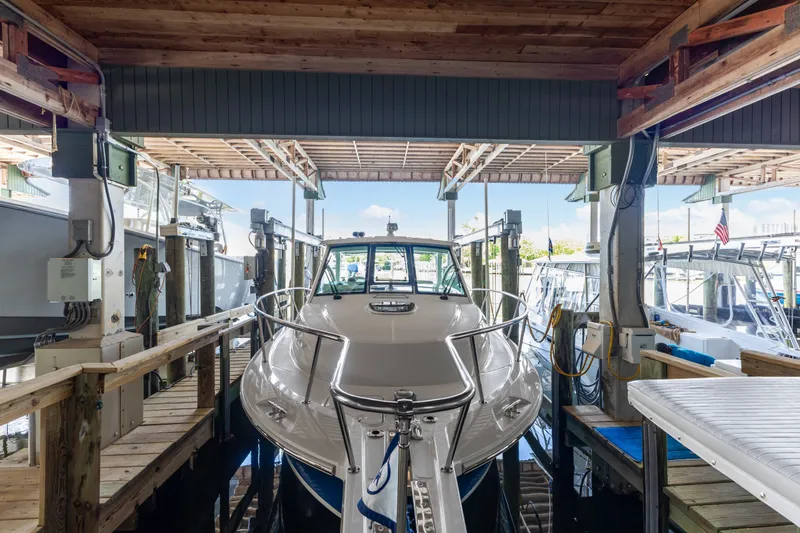 Slide: The Image of 2018 Boston Whaler 345 Conquest docked in a covered marina slip. - 50