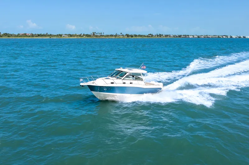 Slide: The Image of 2018 Boston Whaler 345 Conquest cruising on open blue water. - 12