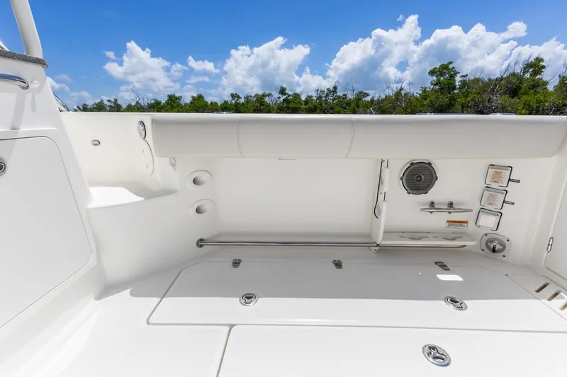 Slide: The Image of 2018 Boston Whaler 345 Conquest boat deck with seating and storage, under a clear blue sky. - 25