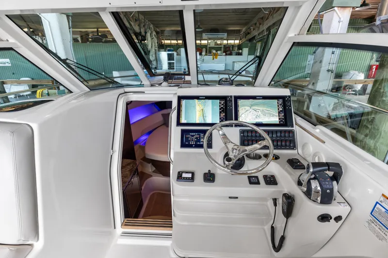 Slide: The Image of 2018 Boston Whaler 345 Conquest helm with advanced navigation displays and controls. - 32