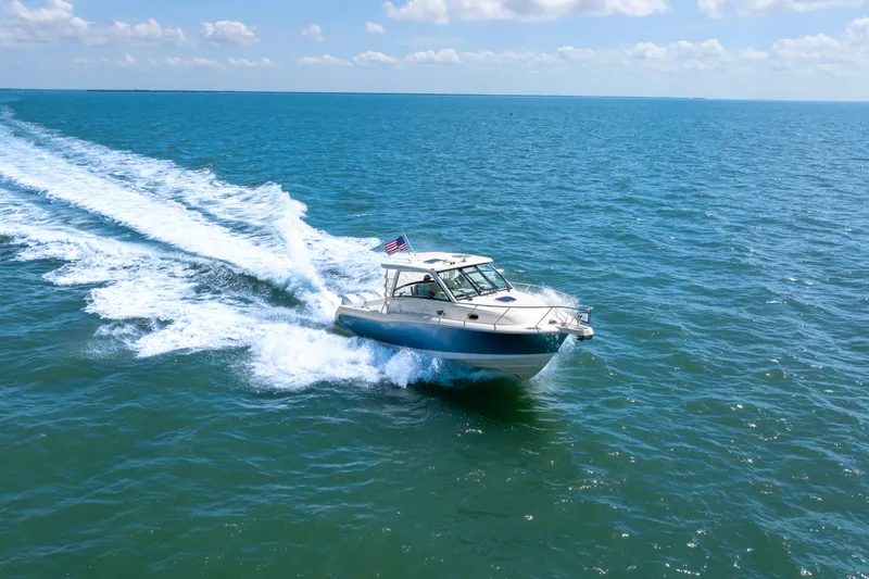 Slide: The Image of Boston Whaler 345 Conquest 2018 cruising on open ocean under clear skies. - 16