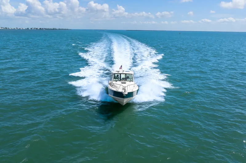 Slide: The Image of 2018 Boston Whaler 345 Conquest cruising on open blue ocean under clear skies. - 14