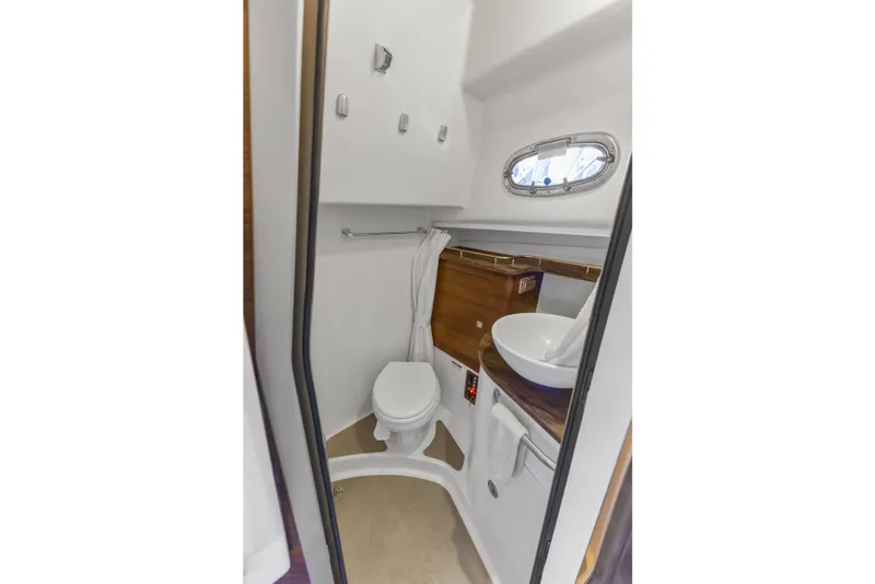 Slide: The Image of Bathroom interior of 2018 Boston Whaler 345 Conquest boat, featuring toilet and sink. - 42
