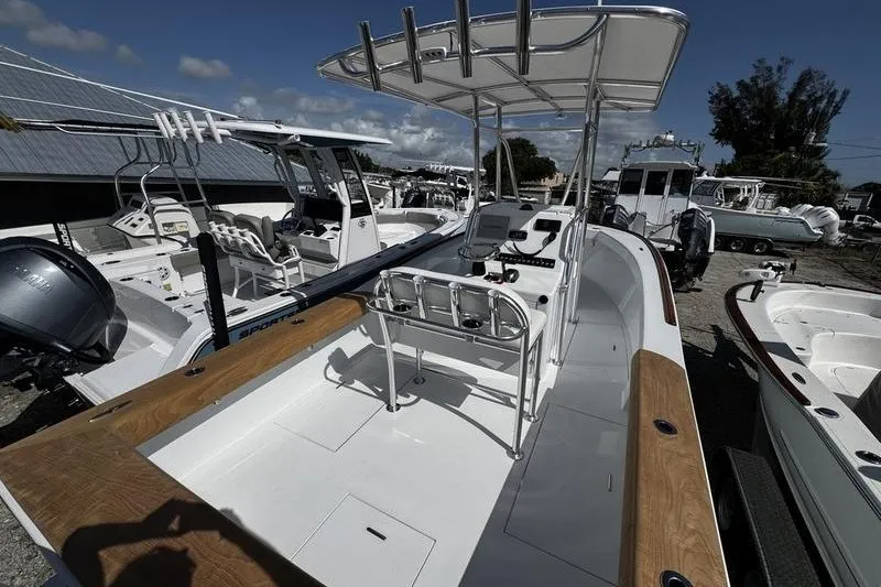 Slide: The Image of 1982 Grady-White Tournament 22 boat with center console and T-top in a marina setting. - 8
