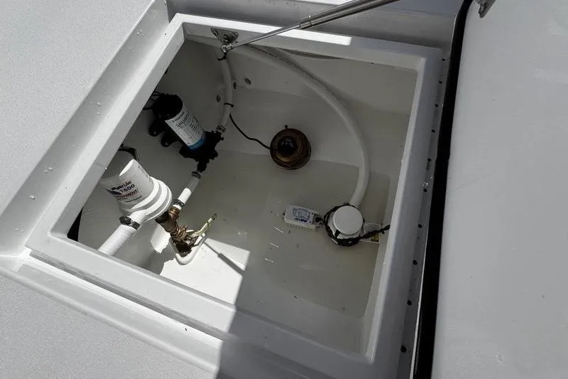 Slide: The Image of 1982 Grady-White Tournament 22 boat compartment with plumbing and filtration system. - 32