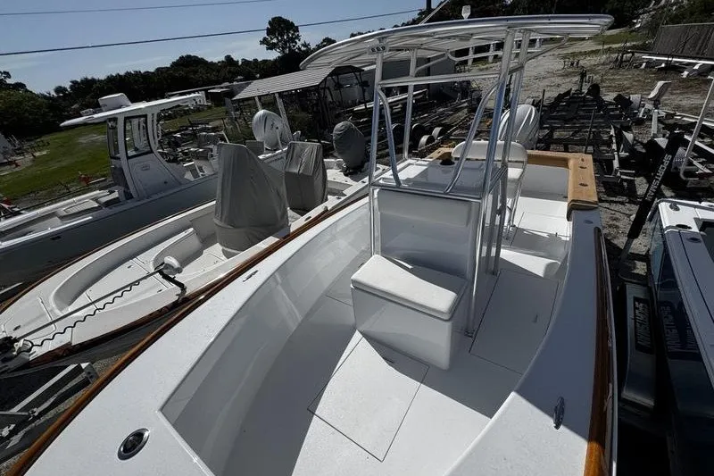 Slide: The Image of 1982 Grady-White Tournament 22 boat with center console and seating, docked outdoors. - 18