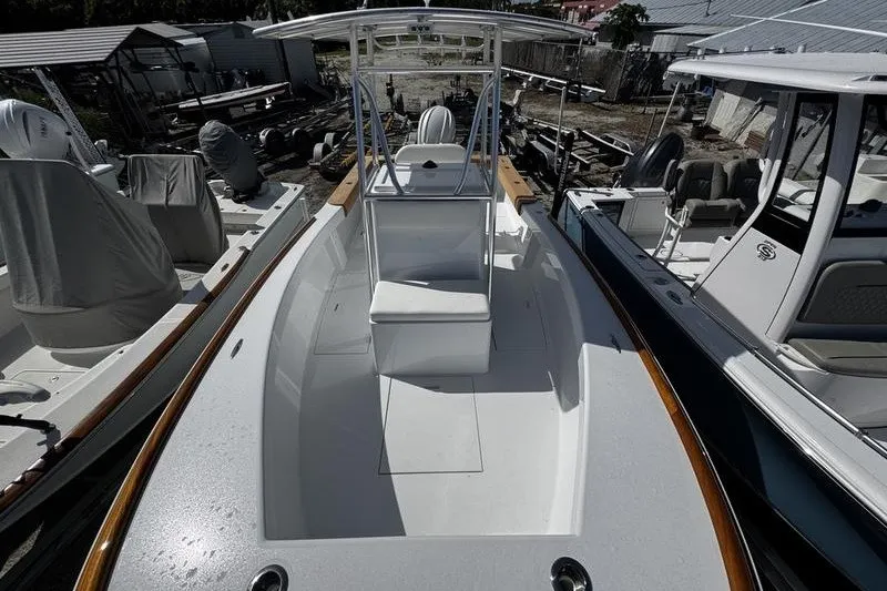 Slide: The Image of 1982 Grady-White Tournament 22 boat with center console and seating, docked among other boats. - 16