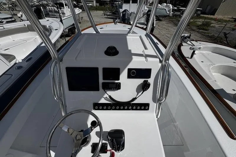 Slide: The Image of 1982 Grady-White Tournament 22 boat dashboard with steering wheel and control panel. - 25