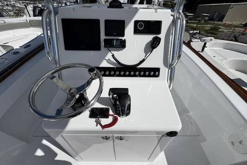 Slide: The Image of 1982 Grady-White Tournament 22 boat console with steering wheel and navigation equipment. - 22