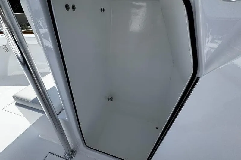 Slide: The Image of 1982 Grady-White Tournament 22 boat storage compartment, featuring sleek white interior design. - 20