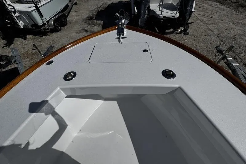 Slide: The Image of 1982 Grady-White Tournament 22 boat deck with storage compartment and wood trim. - 14
