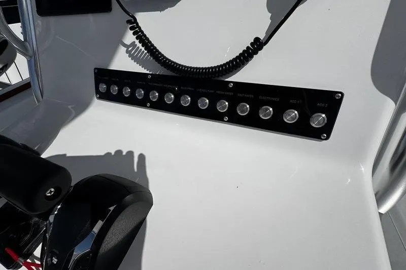 Slide: The Image of Control panel of a 1982 Grady-White Tournament 22 boat with switches and microphone. - 23