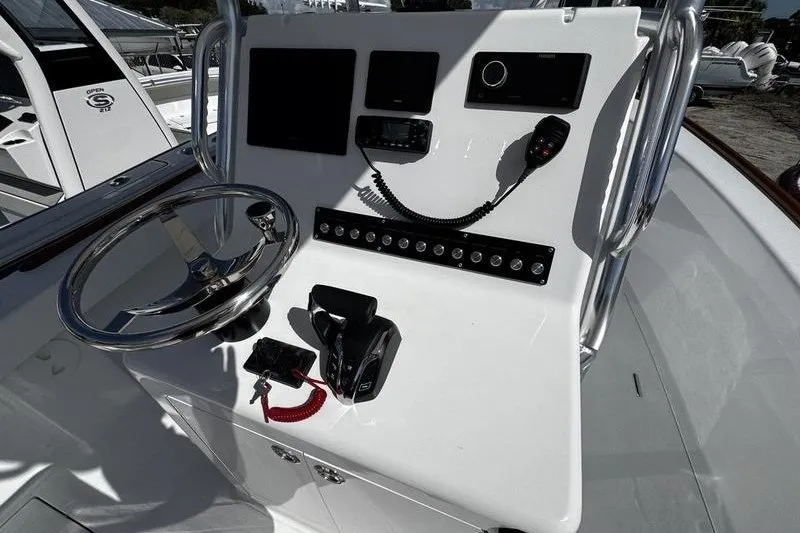 Slide: The Image of 1982 Grady-White Tournament 22 boat dashboard with steering wheel and controls. - 24