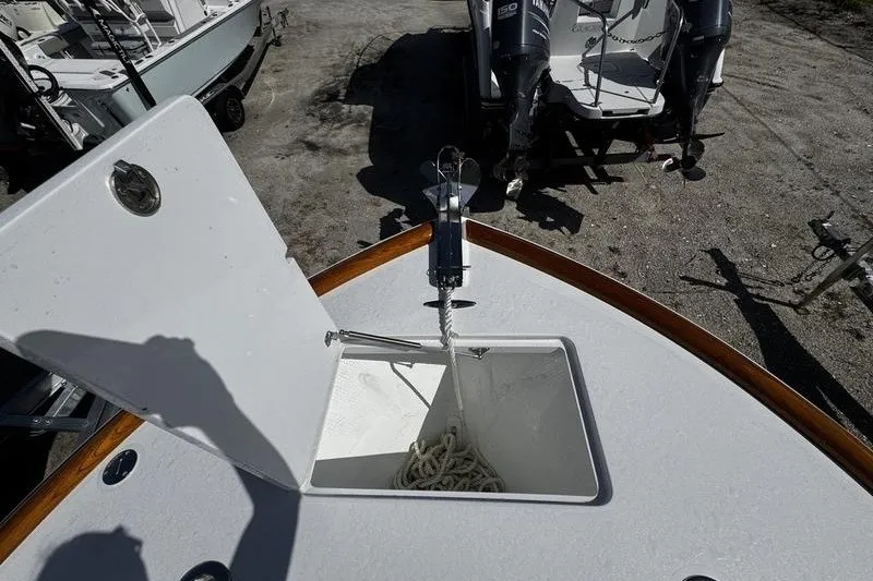 Slide: The Image of 1982 Grady-White Tournament 22 boat anchor compartment with rope, open hatch, and visible outboard motors. - 15