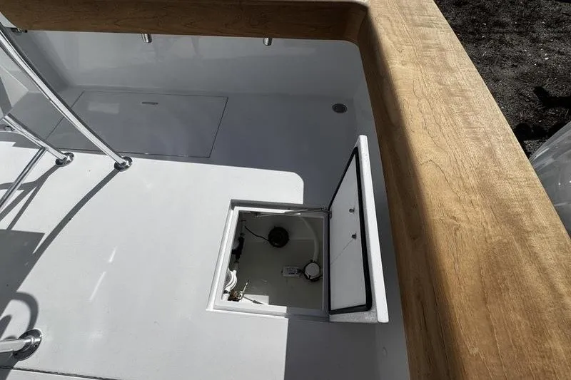 Slide: The Image of 1982 Grady-White Tournament 22 boat interior with open hatch and wooden trim. - 33