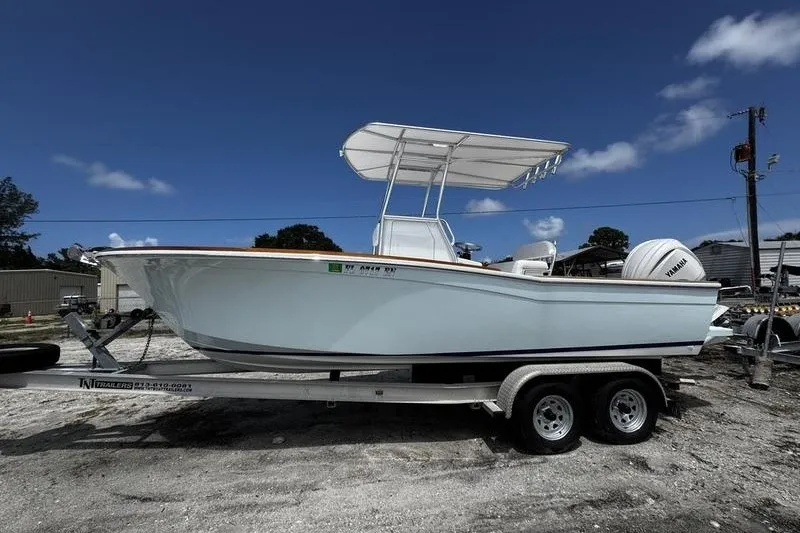 The Image of 1982 Grady-White Tournament 22 boat on trailer, under clear blue sky. - 1