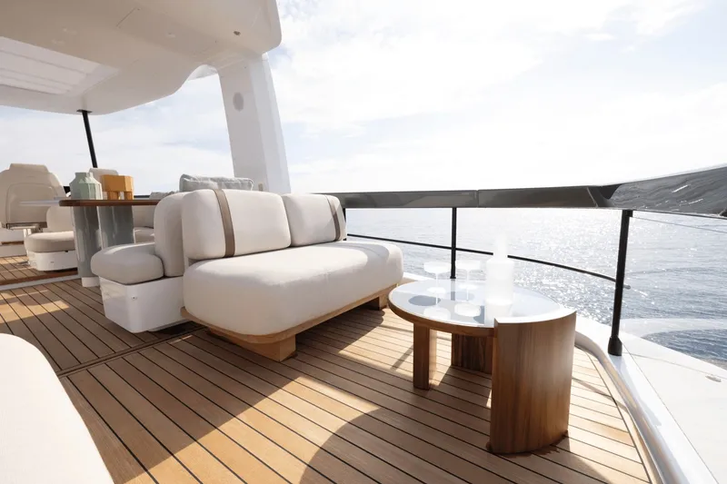 Slide: The Image of The 2027 Azimut Fly 62 features an elegant deck with modern furniture and ocean views. - 10