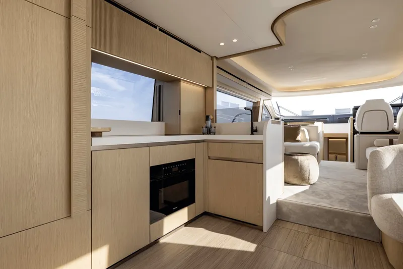 Slide: The Image of Interior of a modern yacht with sleek wood accents and a built-in oven. - 13