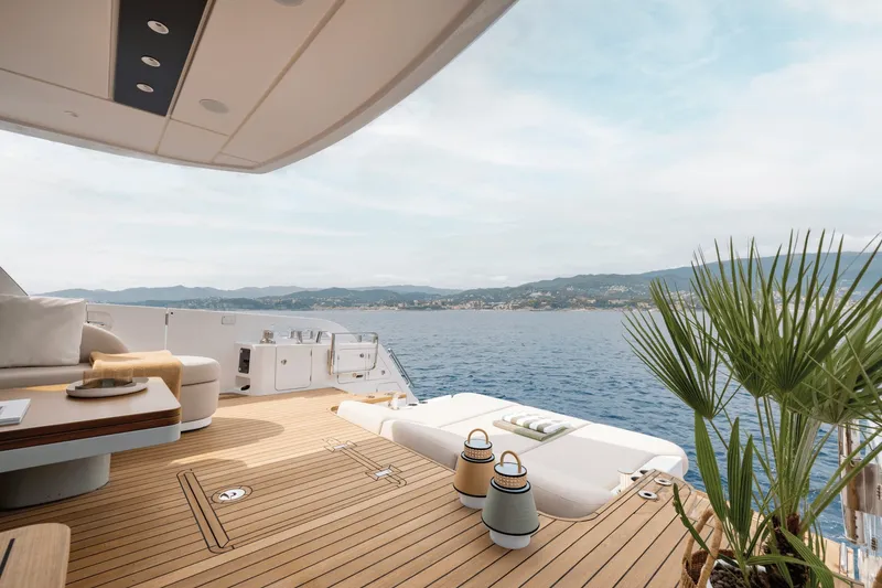 Slide: The Image of The deck of a luxury yacht overlooking the sea and coastline. - 7