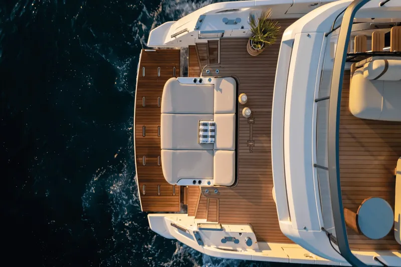 Slide: The Image of The 2027 Azimut Fly 62 features an elegant deck design with luxurious seating and wooden flooring. - 5