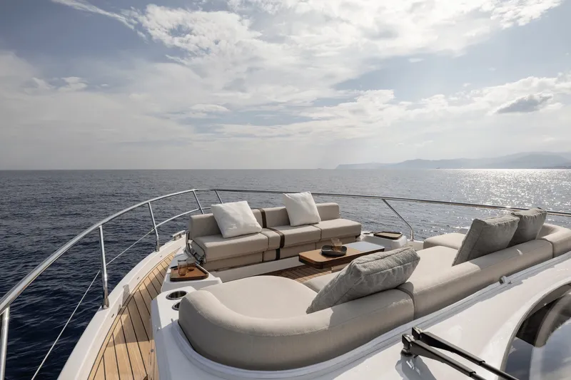 Slide: The Image of The 2027 Azimut Fly 62 features an elegant deck with luxurious seating and ocean views. - 11